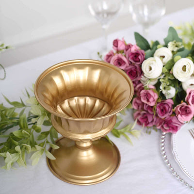 Gold decorative bowl centerpiece with floral arrangement.