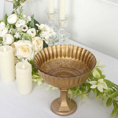 Decorative gold bowl with ornate design surrounded by flowers and candles.