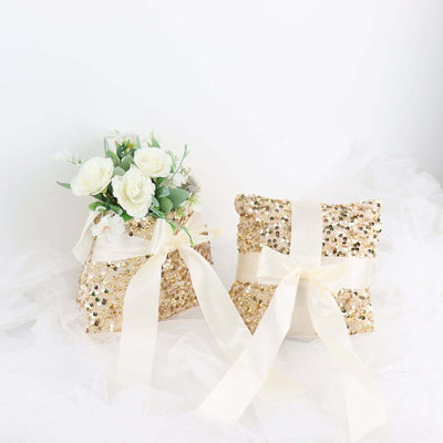 Gold sequin gift bags with white ribbons and floral accents