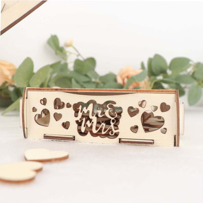 Wooden "Mr & Mrs" sign with heart cutouts in a decorative box.
