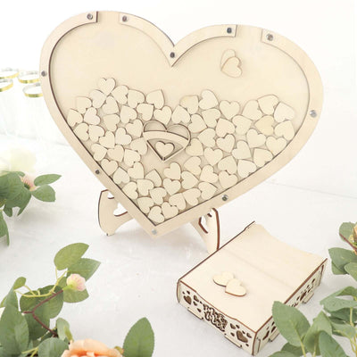 Wooden heart-shaped guestbook with small heart cutouts and matching box.