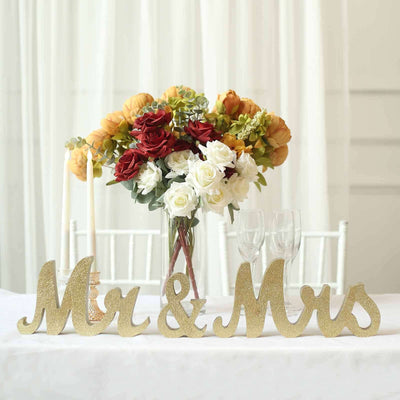 "Mr & Mrs decorative sign with floral centerpiece on a table"