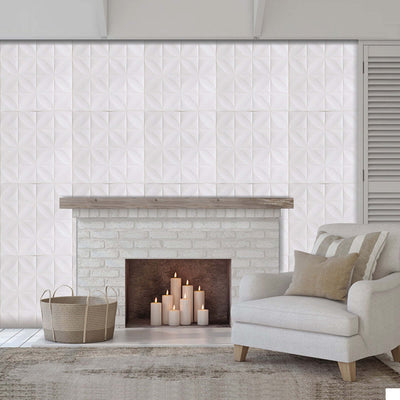 Modern living room with white textured wall, cozy armchair, and candles in fireplace.