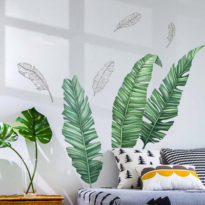 Decorative leaf wall decals in a cozy living room setting.