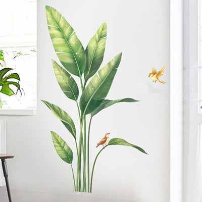 Decorative wall mural of green leaves and a bird on a white background.