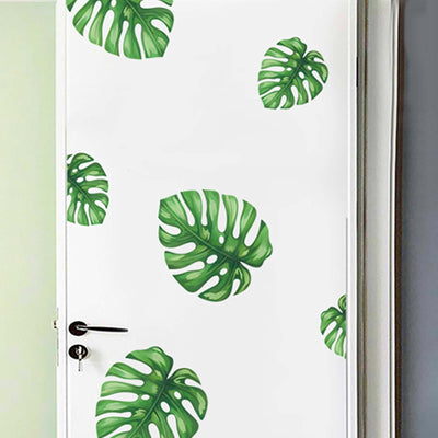 Monstera leaf wall decals on a white door.