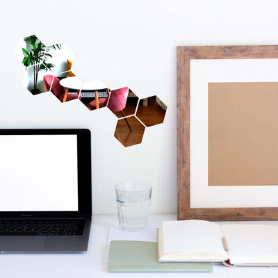 Hexagon collage of home decor with plants and furniture elements.