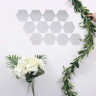 Hexagon wall decals with greenery and white flowers on a white background.