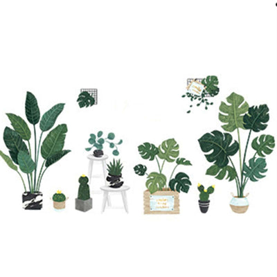Assorted indoor plants in decorative pots and stands, showcasing vibrant greenery.