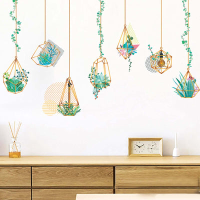 Hanging geometric planters with plants on a stylish interior wall.