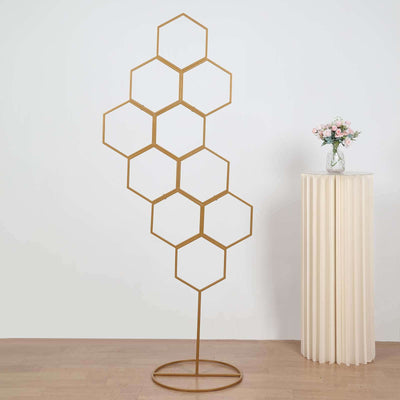Gold hexagon display stand on a plain background.