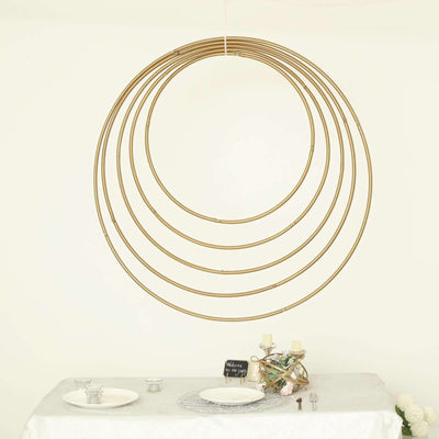 Gold circular decor rings hanging above a dining table setting