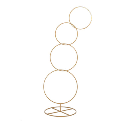 Gold metal circle sculpture with four stacked rings on a base
