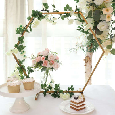 Floral hexagon backdrop with cupcakes and cake, perfect for events.