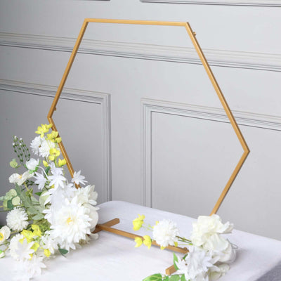 Hexagon photo frame with floral accents on a table.