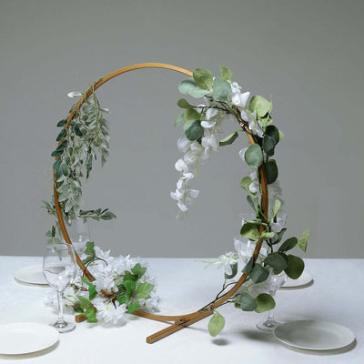 Decorative floral arch with greenery and white flowers for events or ceremonies.