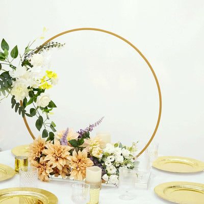 Floral centerpiece with gold hoop for elegant table setting