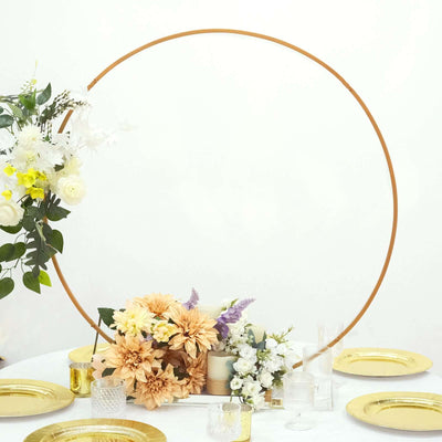 Decorative floral arrangement with gold plates and a circular backdrop for events.