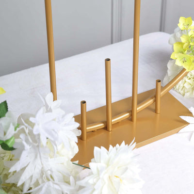 Gold metal flower vase stand with multiple tubes for arranging flowers.