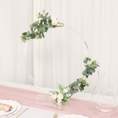 Acrylic floral hoop centerpiece with greenery and white roses.