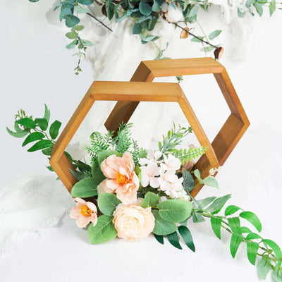 Wooden hexagon decor with faux flowers and greenery arrangement.