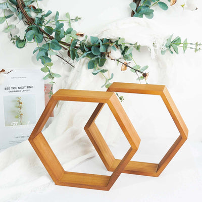 Wooden hexagon decor pieces with greenery in a styled scene.