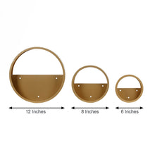 Three hanging metal round wall planters with clear acrylic panels in gold color