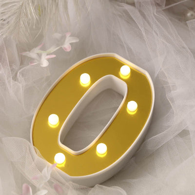 Yellow LED letter "O" with lights on a soft, textured backdrop.