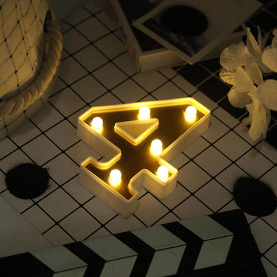 Light-up number 4 decoration with warm LED lights on a table