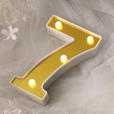 Gold number 7 light-up decoration on a soft background.