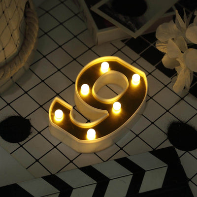Decorative LED number 9 light in white and gold, perfect for home decor.