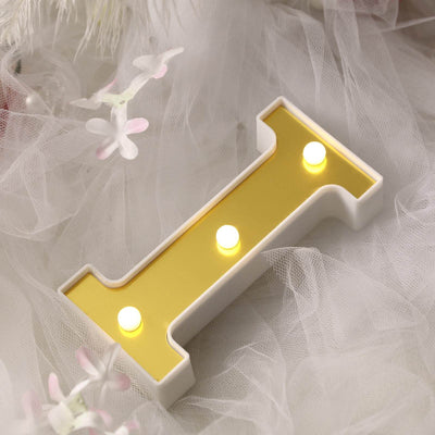 Decorative letter "I" with lights on a soft background.
