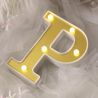 Decorative illuminated letter "P" with yellow accents and lights.
