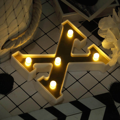 Decorative letter X with LED lights on a stylish surface