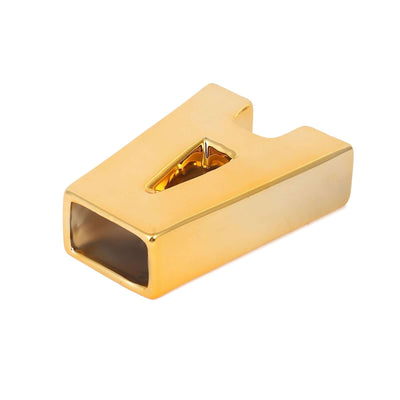 Gold paperweight in a modern design, showcasing a sleek, polished finish.