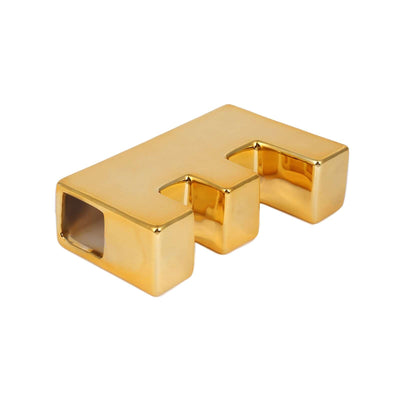 Gold decorative letter "F" sculpture on white background