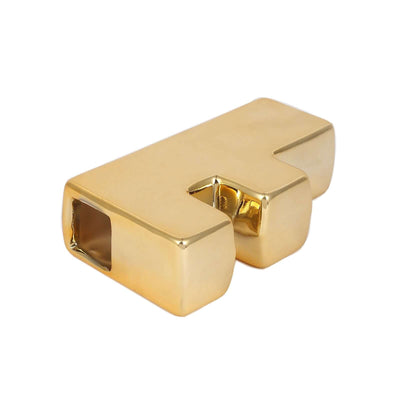 Gold decorative paperweight in a unique geometric shape.