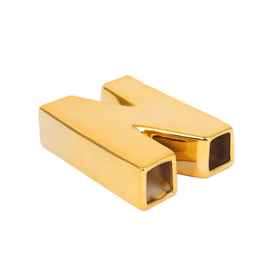 Gold letter "N" decorative piece on white background