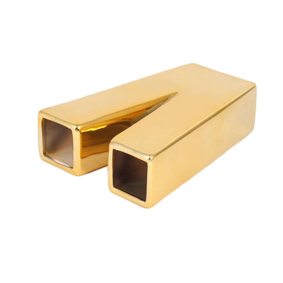Gold geometric vase with square openings, modern decor accent.