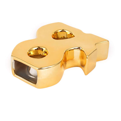 Gold dollar sign paperweight with two candle holders