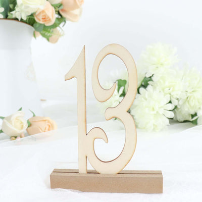 Wooden number 13 decoration with a natural finish and a base.