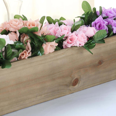 Wooden planter box with pink and purple artificial roses