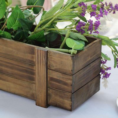 Wooden planter box with greenery and purple flowers.