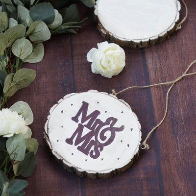 Wooden wedding sign with "Mr & Mrs" in purple on a rustic background.