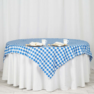 Blue and white checkered tablecloth draped over a round table
