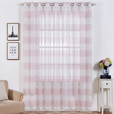Sheer pink striped curtains hanging in a stylish living room setting.