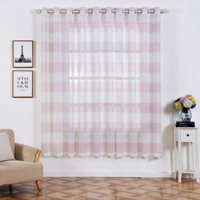 Sheer pink striped curtain hanging in a stylish living room setting.