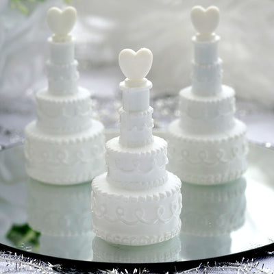 Miniature white wedding cake decorations with heart toppers. #whtbkgd
