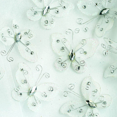 Sparkling butterfly embellishments with silver accents on a light background.