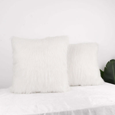 Fluffy white decorative pillows on a soft surface
